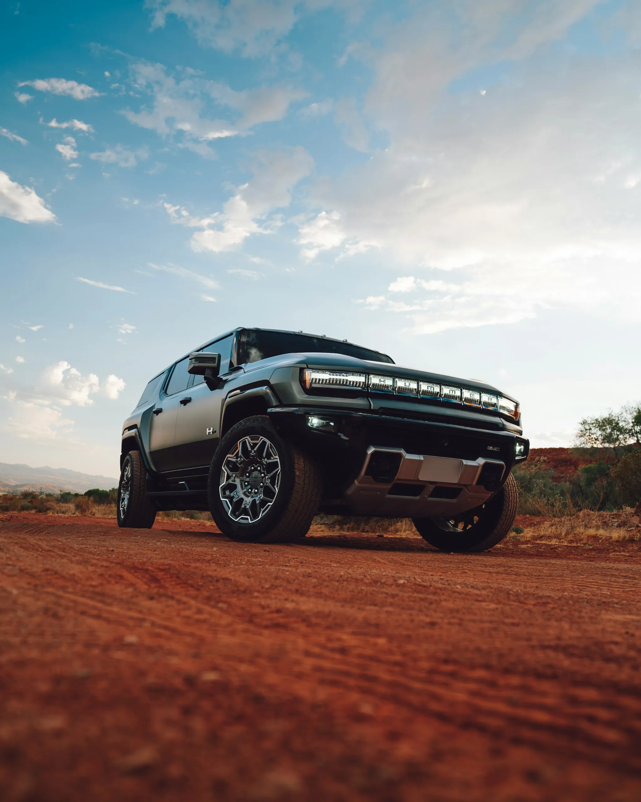 A truck is parked on a dirt road