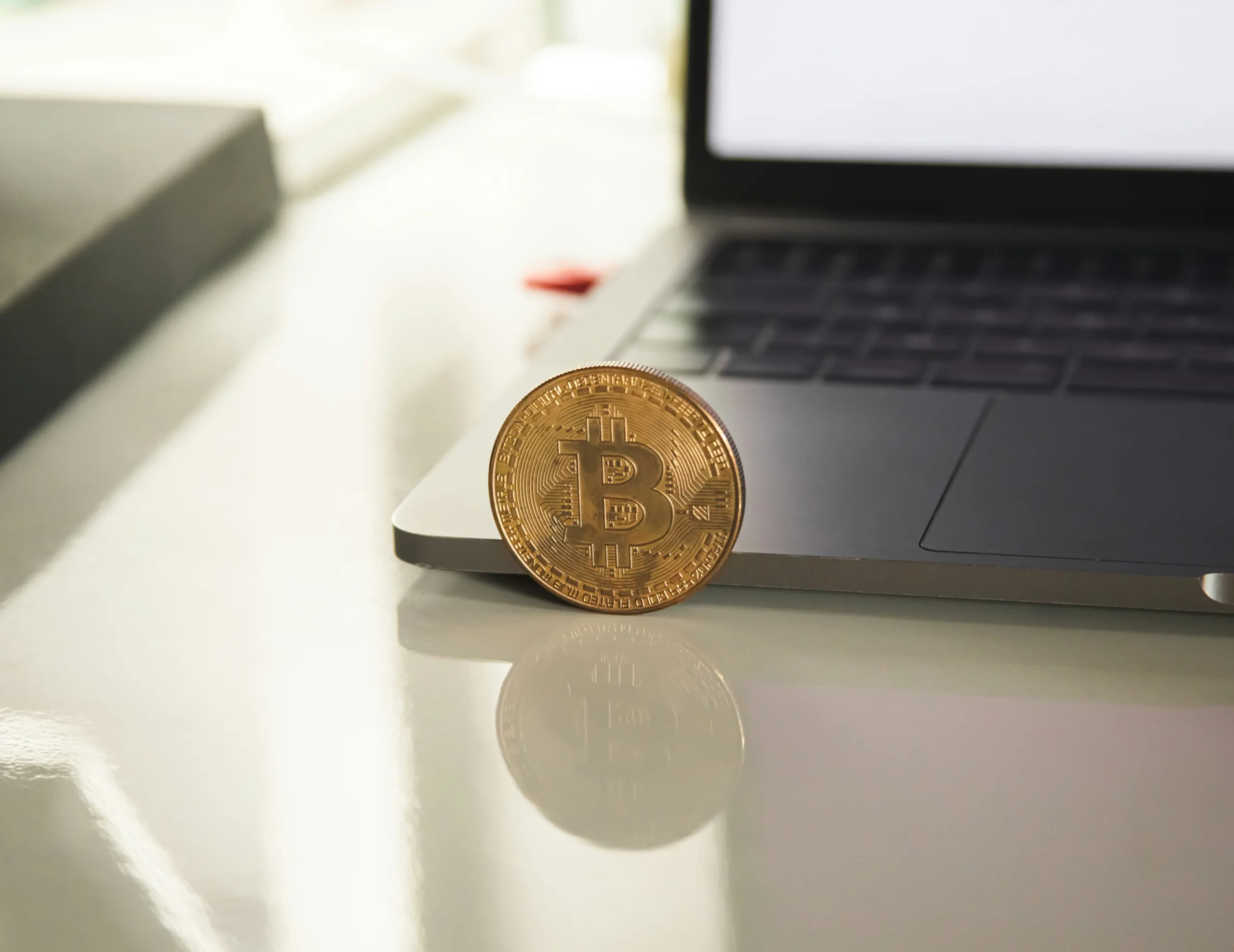 silver round coin on white table