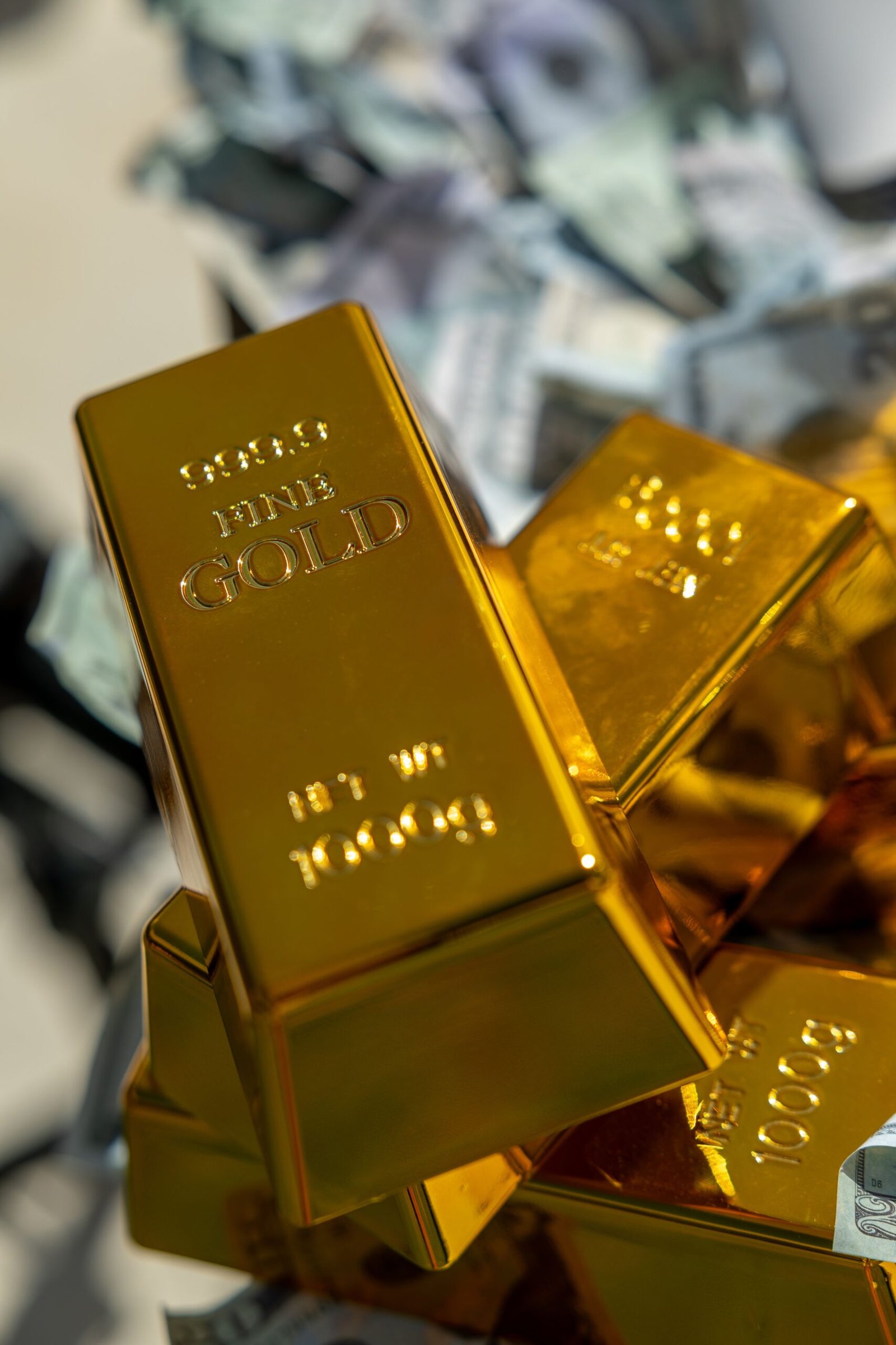 Gold bars on cash background representing Iran Gulf diplomatic talks impact on markets