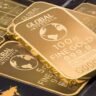 Gold bars representing OPEC+ oil output decision and commodity markets