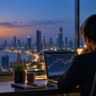 Indian financial journalist reviews market charts at a desk overlooking Mumbai at twilight